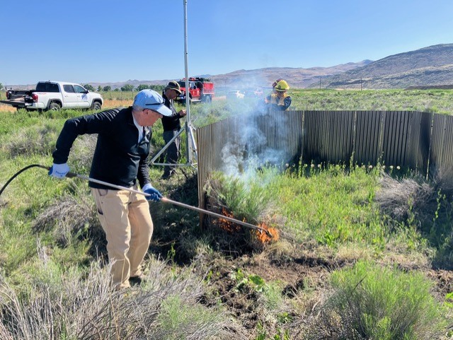 ECO lead Dr. Jay Arnone igniting "barrel burn” at our "University Farm” test site